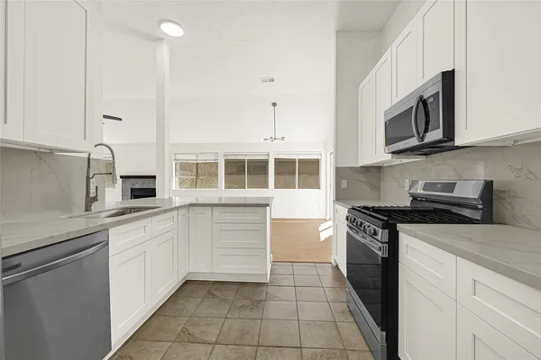 a kitchen with stainless steel appliances granite countertop a stove and a sink