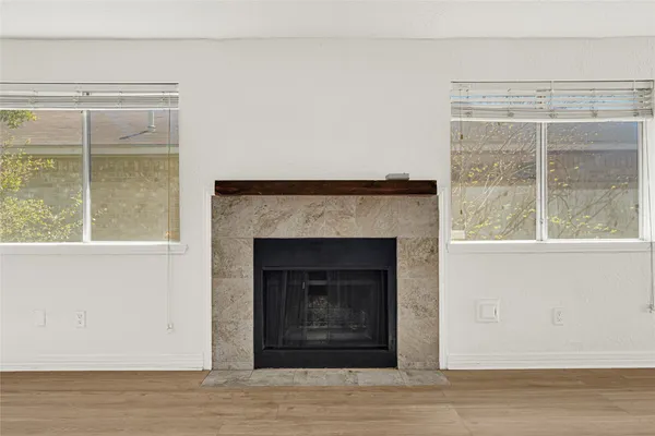 a view of a livingroom with a fireplace and window