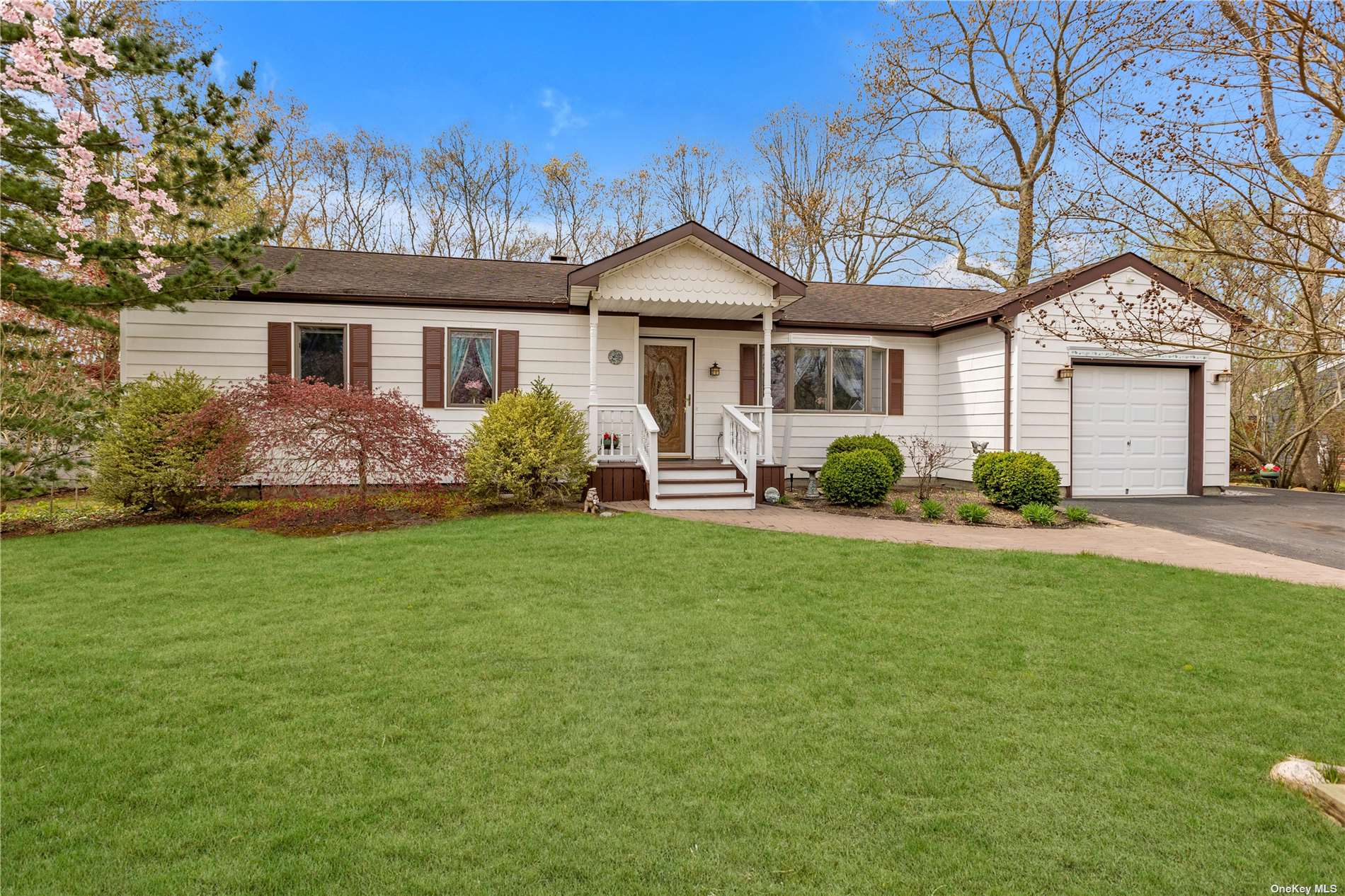 4 Marc Drive Ridge, NY 11961 - Photo 1 of 1 a front view of a house with garden