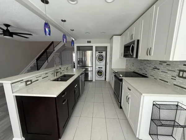 a kitchen with a sink stove and refrigerator