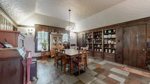 a living room with furniture and a piano