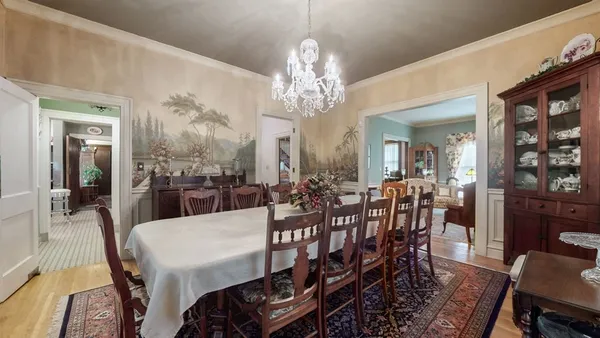 a living room with furniture a window and a chandelier