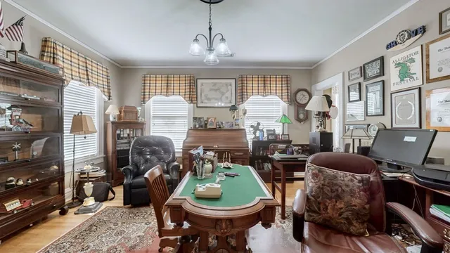 a living room with furniture a fireplace and a large mirror