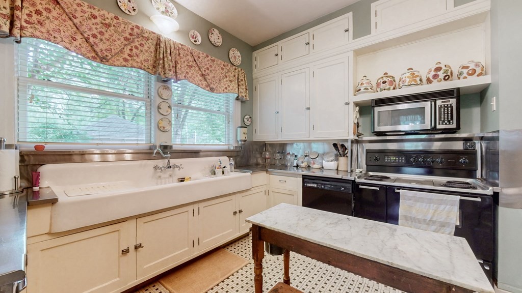 505 Walnut Street Paris, TN 38242 - Photo 17 of 54 a kitchen with a sink stove and microwave