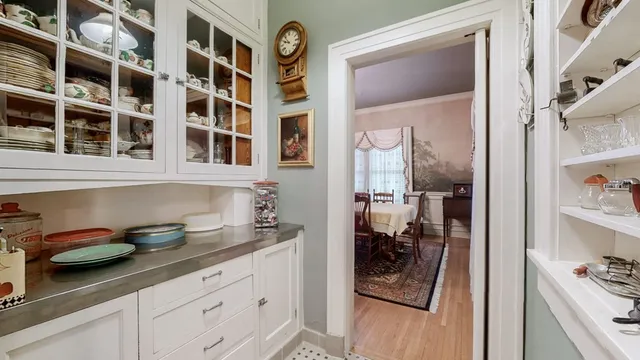a bedroom with a bed mirror and window