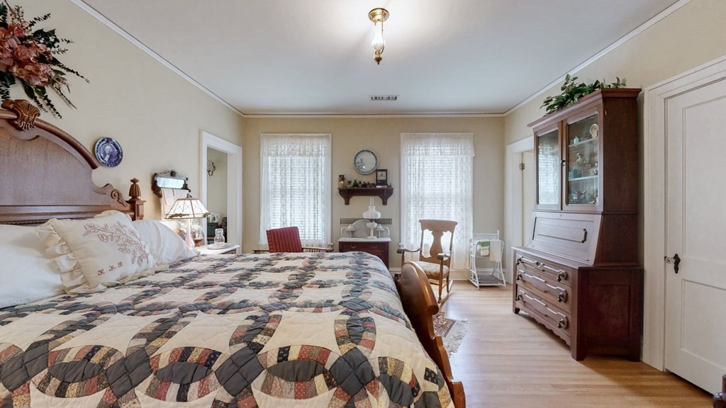 505 Walnut Street Paris, TN 38242 - Photo 27 of 54 a bedroom with a large bed and a wooden floor