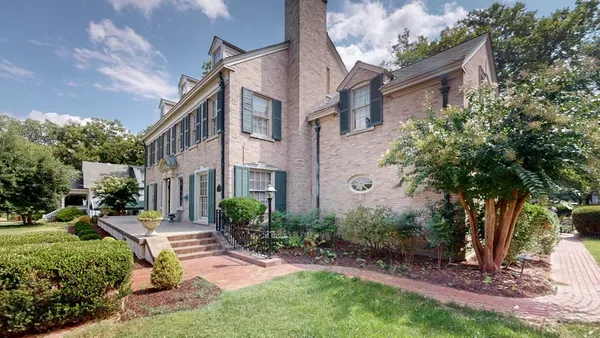 a house view with a sitting space and garden