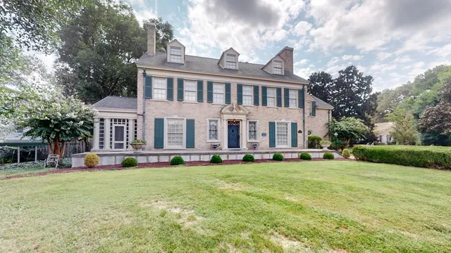 a view of a park that has large trees