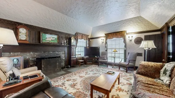 a view of a dining room with furniture and a chandelier