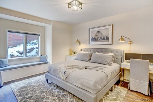 97 Kinney Way, Unit A Winter Park, CO 80482 - Photo 11 of 27 a bedroom with a bed and a painting on the wall