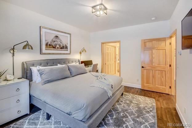 97 Kinney Way, Unit A Winter Park, CO 80482 - Photo 13 of 27 a bedroom with a bed and a chandelier