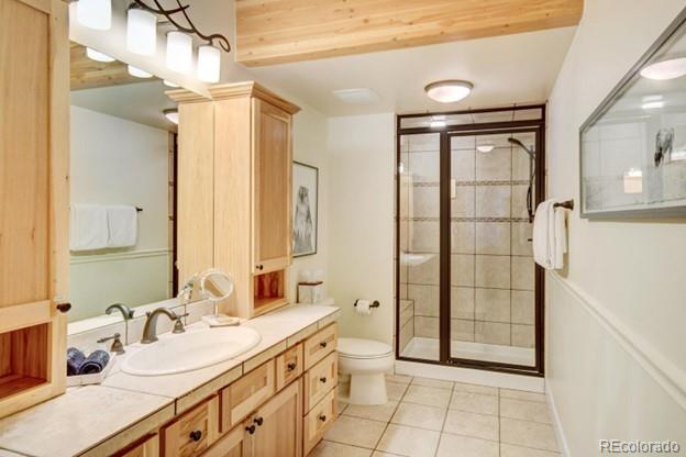 97 Kinney Way, Unit A Winter Park, CO 80482 - Photo 14 of 27 a spacious bathroom with a double vanity sink a mirror and a shower