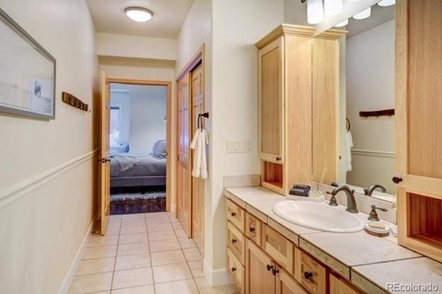 97 Kinney Way, Unit A Winter Park, CO 80482 - Photo 16 of 27 a en suite bathroom with a double vanity sink a mirror and a shower