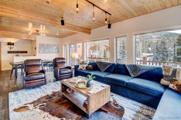 97 Kinney Way, Unit A Winter Park, CO 80482 - Photo 4 of 27 a living room with furniture wooden floor and a table