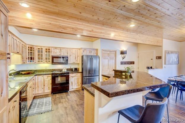 97 Kinney Way, Unit A Winter Park, CO 80482 - Photo 6 of 27 a kitchen with stainless steel appliances granite countertop a stove and refrigerator