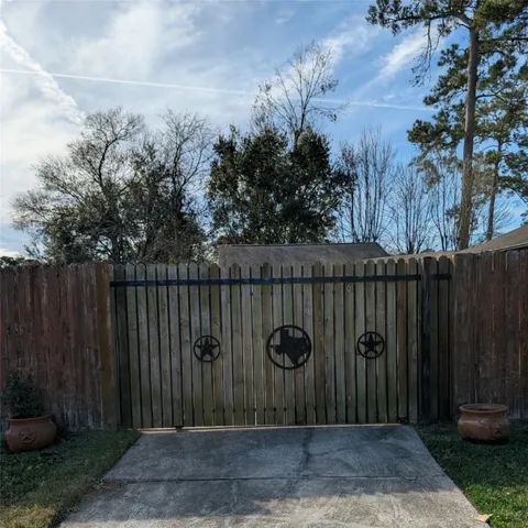 a wooden fence with trees in the background
