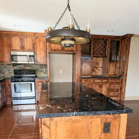 a kitchen with a refrigerator a stove and cabinets