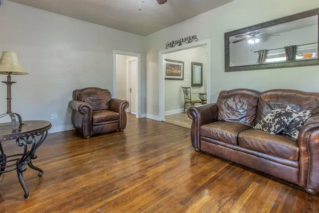 a view of a dining room with furniture wooden floor and a chandelier