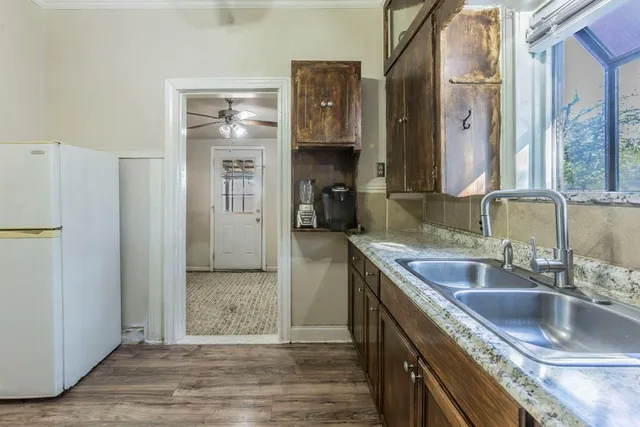 a kitchen with a sink stove and cabinets