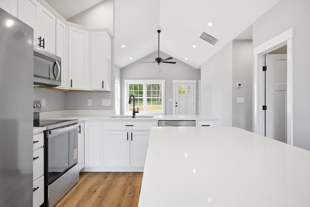 103 Hilltop Terrace Road Staunton, VA 24401 - Photo 10 of 47 a kitchen with stainless steel appliances granite countertop a stove a sink and white cabinets with wooden floor