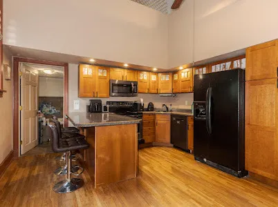 a kitchen with stainless steel appliances a refrigerator stove microwave and cabinets