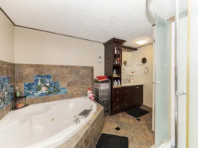 a bathroom with a tub sink and mirror
