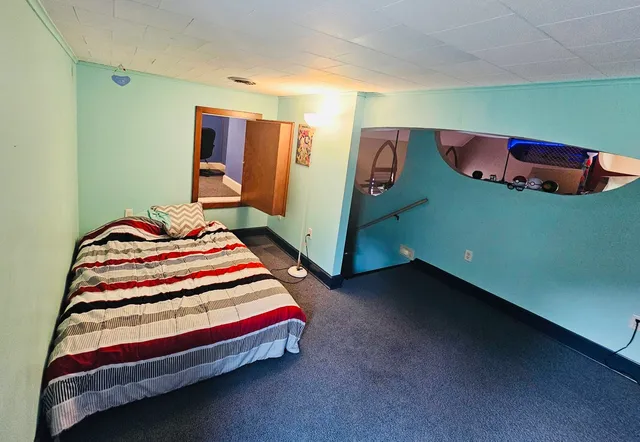 a bedroom with a bed and a dresser