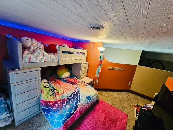a bedroom with a bed and with furniture