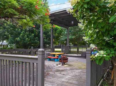 a view of a wooden deck and a backyard