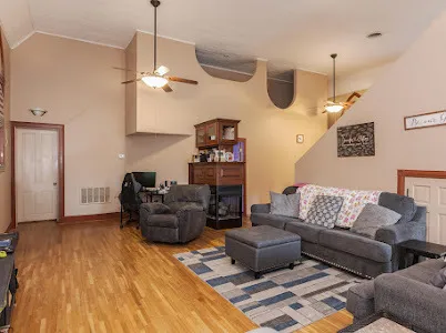 a living room with furniture and wooden floor