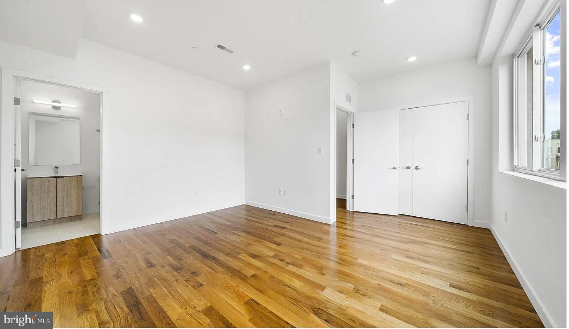 300 Budd Street, Unit D2 Philadelphia, PA 19104 - Photo 18 of 23 an empty room with wooden floor and windows