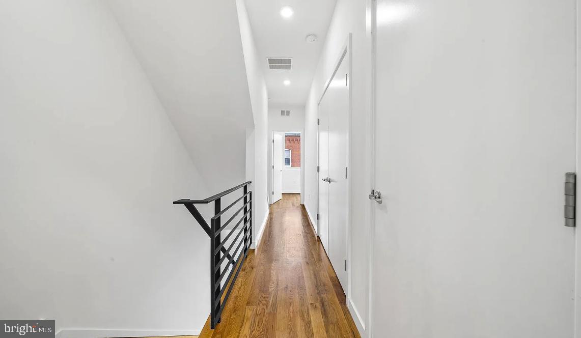 300 Budd Street, Unit D2 Philadelphia, PA 19104 - Photo 21 of 23 a view of a hallway with wooden floor and staircase