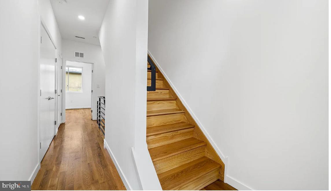 300 Budd Street, Unit D2 Philadelphia, PA 19104 - Photo 22 of 23 a view of a hallway with wooden floor and staircase