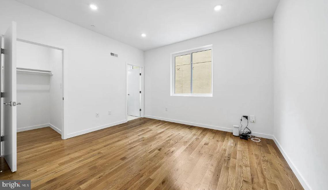 300 Budd Street, Unit D2 Philadelphia, PA 19104 - Photo 10 of 23 a view of empty room with wooden floor and fan