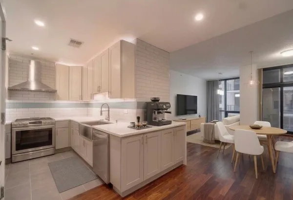 a kitchen with a sink cabinets and wooden floor