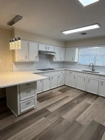 a kitchen with a sink cabinets and window