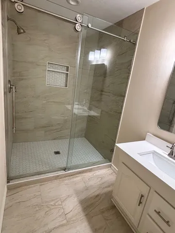 a bathroom with a shower and a sink