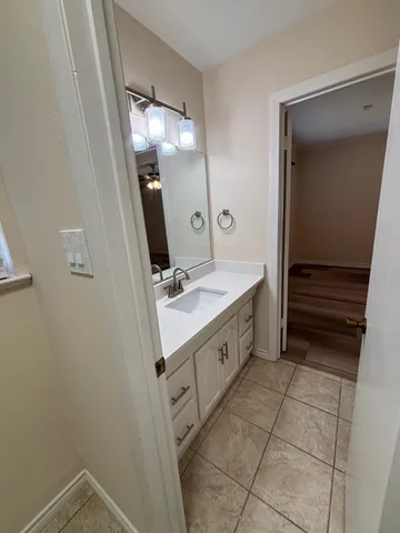 a bathroom with a sink a toilet and mirror