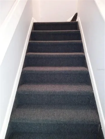 a view of staircase with white walls