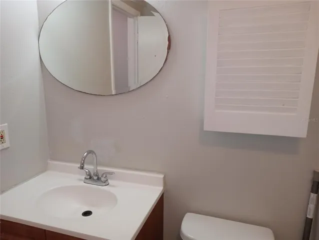 a white toilet sitting next to a bathroom sink