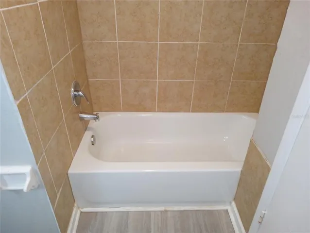 a view of a room with wooden floor