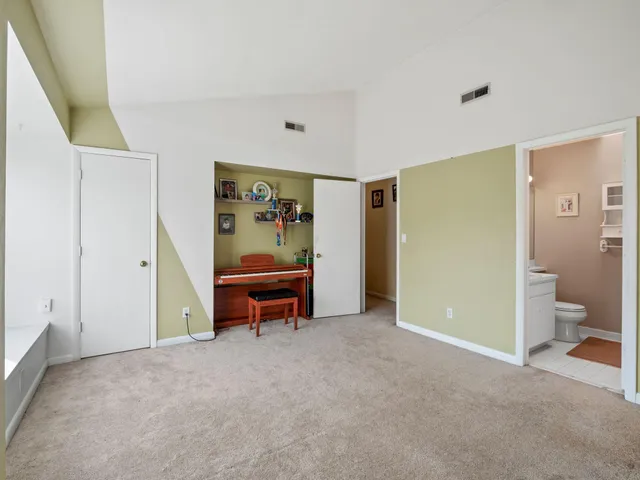 a view of room with furniture and a fan