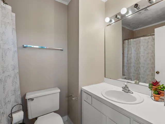 a bathroom with a sink toilet and a mirror