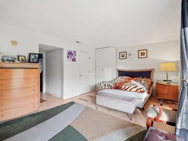 a bedroom with a bed and dresser