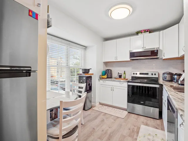 a kitchen with stainless steel appliances granite countertop a stove and a sink