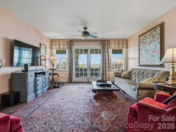 a kitchen with stainless steel appliances granite countertop a sink a stove and white cabinets
