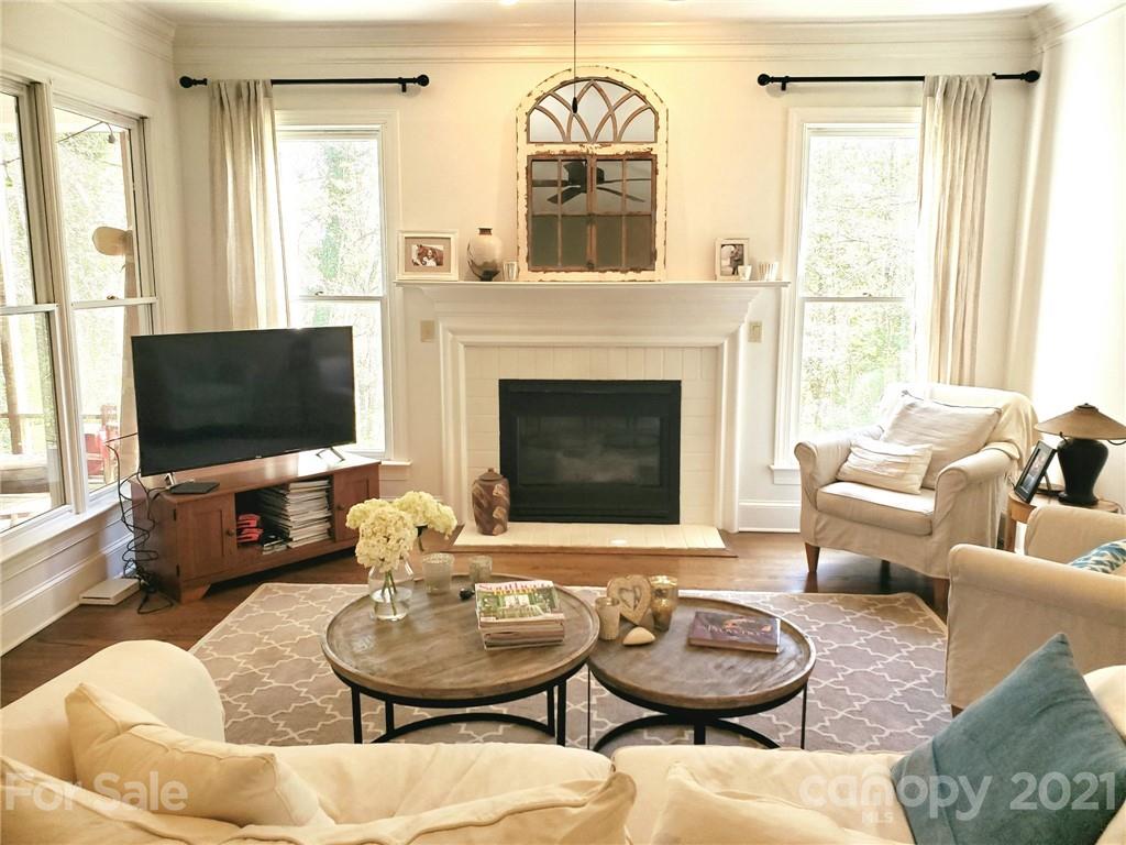 143 Morrison Hill Road Davidson, NC 28036 - Photo 4 of 17 a living room with furniture a flat screen tv and a fireplace