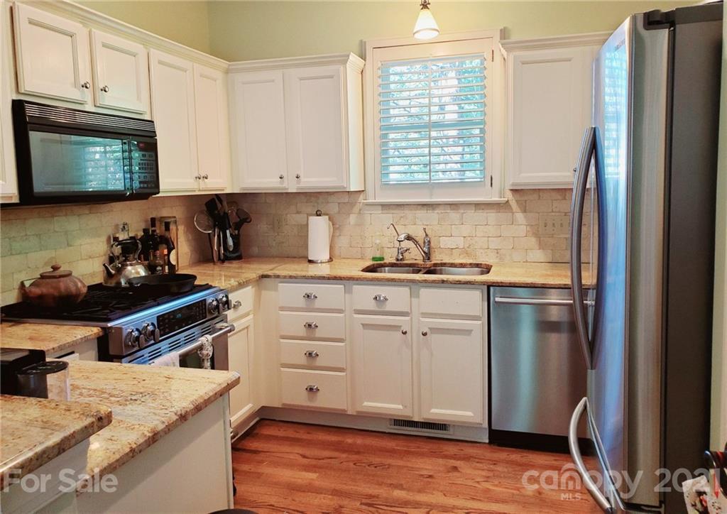 143 Morrison Hill Road Davidson, NC 28036 - Photo 6 of 17 a kitchen with stainless steel appliances white cabinets and a stove top oven