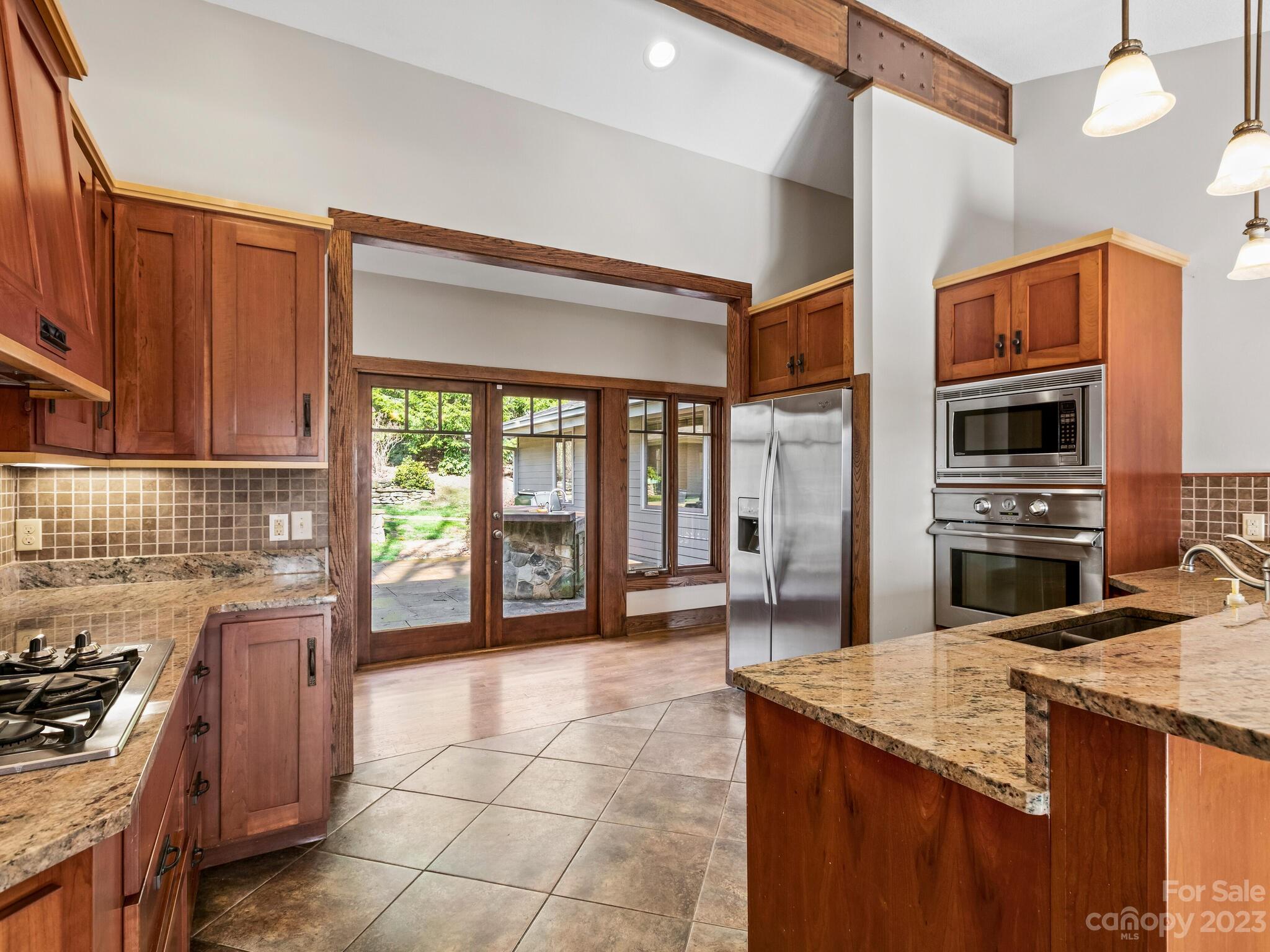 122 Emmas Grove Road Fletcher, NC 28732 - Photo 11 of 48 a kitchen with stainless steel appliances granite countertop a stove a sink and a microwave
