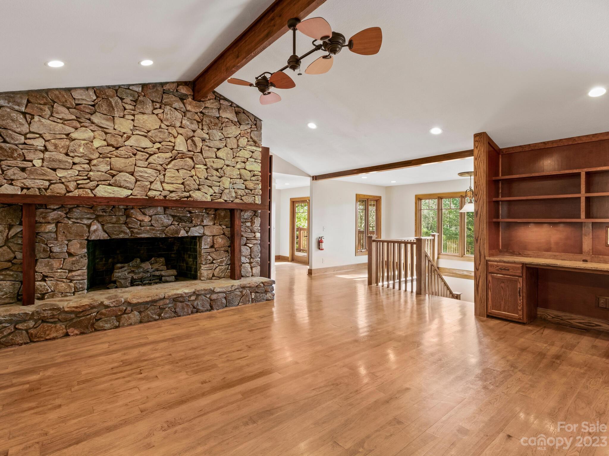 122 Emmas Grove Road Fletcher, NC 28732 - Photo 13 of 48 an empty room with wooden floor fireplace and windows